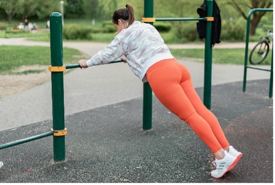 Woman exercising using a bar in a park.jpg